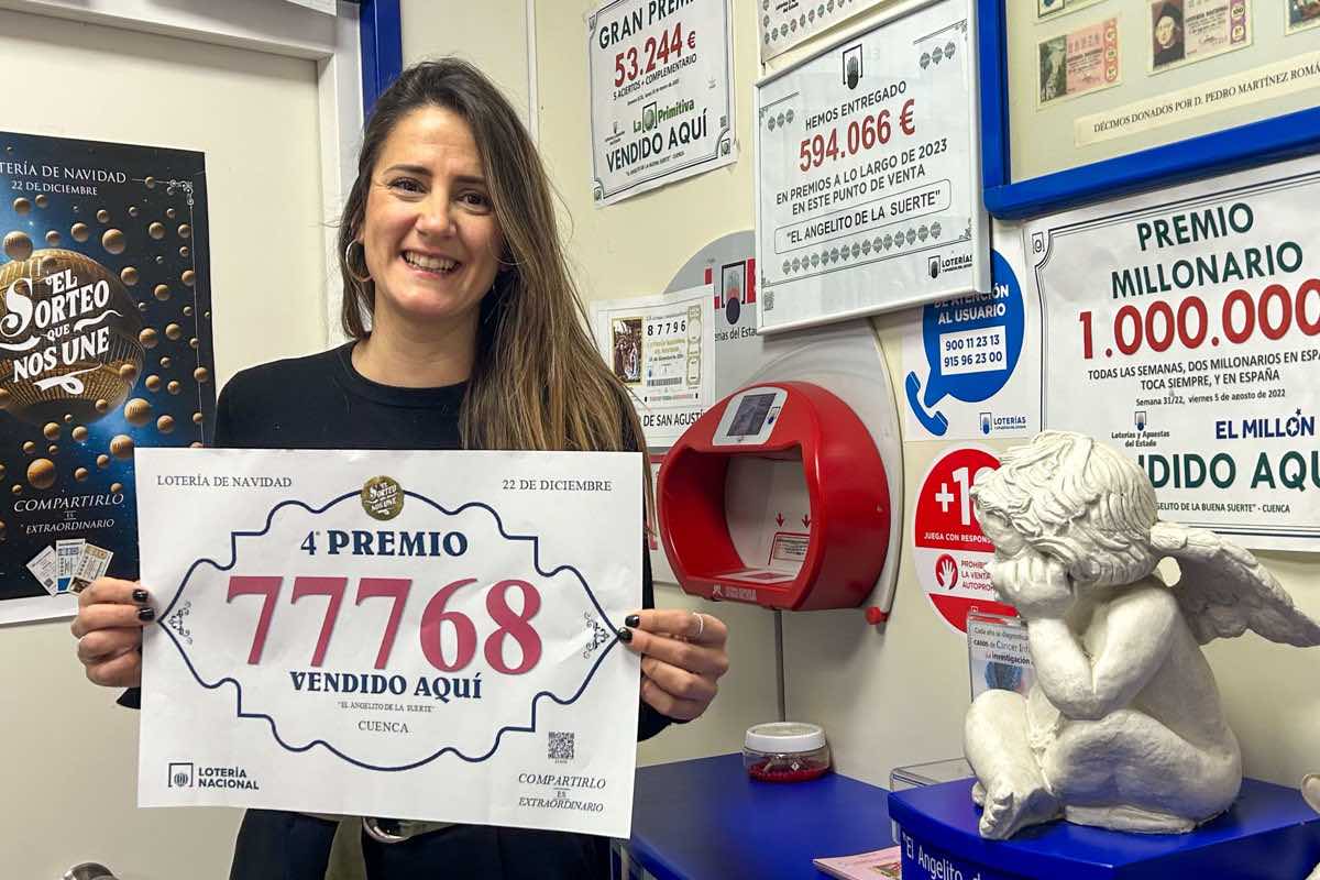 Clara Cañizares, lotera de la administración 10 'El Angelito de la Suerte' de Cuenca, muestra el número 77768, premiado con un cuarto premio de la Lotería de Navidad. EFE/Lorena Mayordomo